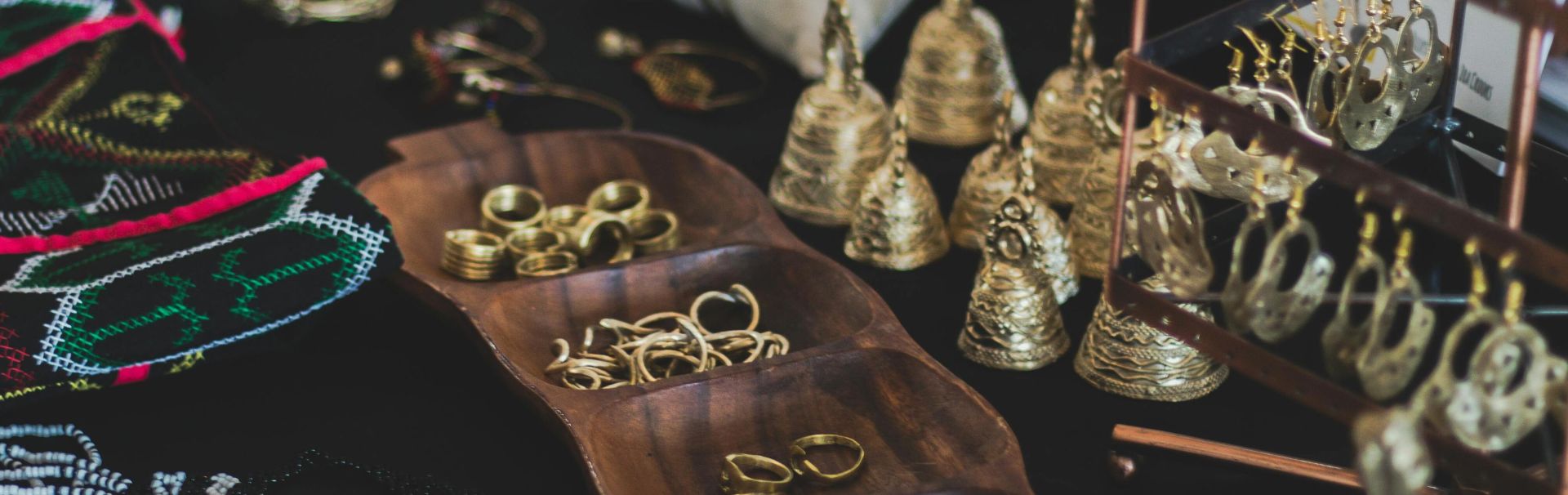 Close-up of a variety of elegant jewelry, including rings, earrings, and necklaces on display indoors.